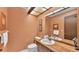 Powder room with wood vanity and framed mirror at 1316 Cambron Dr, Valrico, FL 33596