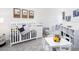 Bedroom features decor, crib, changing table, and play area at 2767 Walden Town Cir, Plant City, FL 33566