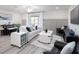 Bright living room with stylish furniture, neutral colors, and an entertainment center at 2767 Walden Town Cir, Plant City, FL 33566