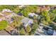 An aerial shot of the home with its fenced backyard, mature landscaping, and nearby street at 3105 N 17Th St, Tampa, FL 33605