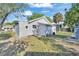 Cozy backyard with partial view of gray single Gathering home and vibrant trees at 3105 N 17Th St, Tampa, FL 33605
