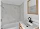 Bright bathroom showcases an updated vanity, mirror, sink, toilet, and shower with tub at 3105 N 17Th St, Tampa, FL 33605