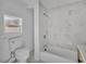 Clean bathroom has a shower, toilet, and window that provides natural light at 3105 N 17Th St, Tampa, FL 33605