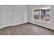 This bedroom has a neutral paint, wood-look floors, a window, and a closet at 3105 N 17Th St, Tampa, FL 33605