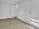 Bright bedroom featuring clean white walls and new laminate floors with two doors at 3105 N 17Th St, Tampa, FL 33605