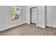 Cozy bedroom offers wood-look floors, a window, and a closet with open doors at 3105 N 17Th St, Tampa, FL 33605