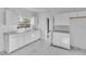 Modern kitchen featuring sleek cabinetry, marble floors, quartz countertops, and a bright window at 3105 N 17Th St, Tampa, FL 33605