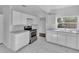 Modern kitchen with white cabinets, stainless steel appliances, and marble flooring at 3105 N 17Th St, Tampa, FL 33605