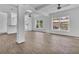 Spacious living room with beamed ceilings, ceiling fans, and natural light from large windows at 3105 N 17Th St, Tampa, FL 33605