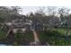 Aerial view of the backyard featuring a screened pool, storage shed, and mature landscaping at 5903 Cachette De Riviera Ct, New Port Richey, FL 34655