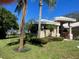 Elegant front exterior featuring a welcoming entrance framed by lush, well-maintained landscaping at 5903 Cachette De Riviera Ct, New Port Richey, FL 34655