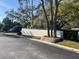 Street view of a community wall and a nicely landscaped entrance at 5903 Cachette De Riviera Ct, New Port Richey, FL 34655