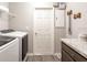 Well-organized laundry room featuring modern washer and dryer, cabinet space, and a functional layout at 7076 162Nd E Pl, Parrish, FL 34219