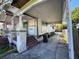 This single-story home has a covered parking area, gated access, and overgrown yard at 921 E 12Th Ave, Tampa, FL 33605