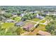 Aerial view of homes nestled in a serene neighborhood with a lake view at 12500 Green Oak Ln, Dade City, FL 33525