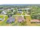 Aerial view of homes near a lake, surrounded by lush trees at 12500 Green Oak Ln, Dade City, FL 33525
