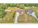 Aerial view of a beautiful home with a long drive surrounded by greenery at 12500 Green Oak Ln, Dade City, FL 33525
