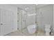Modern bathroom featuring glass shower, soaking tub, and neutral tile at 12500 Green Oak Ln, Dade City, FL 33525