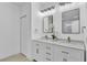 Bright bathroom with dual sinks and modern lighting fixtures at 12500 Green Oak Ln, Dade City, FL 33525