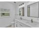 Bathroom featuring dual sinks, modern fixtures, and natural light at 12500 Green Oak Ln, Dade City, FL 33525