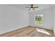 Bright bedroom features wood floors, a window, and ceiling fan at 12500 Green Oak Ln, Dade City, FL 33525