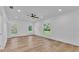 Bright bedroom with hardwood floors, recessed lighting, and multiple windows offering views at 12500 Green Oak Ln, Dade City, FL 33525