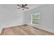 Bright bedroom features wood floors, a window, and ceiling fan at 12500 Green Oak Ln, Dade City, FL 33525