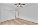 Bright bedroom features wood floors, a closet, and ceiling fan at 12500 Green Oak Ln, Dade City, FL 33525