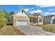 Well-maintained home with a two-car garage and a brick-paved driveway at 12500 Green Oak Ln, Dade City, FL 33525