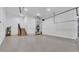 Spacious garage interior featuring stairs, overhead lighting, and painted walls at 12500 Green Oak Ln, Dade City, FL 33525