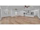 Large living space with wood floors connecting to the kitchen at 12500 Green Oak Ln, Dade City, FL 33525