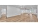 Spacious living room with hardwood floors and modern lighting fixtures throughout the home at 12500 Green Oak Ln, Dade City, FL 33525