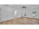 Spacious main bedroom featuring hardwood floors, multiple windows, and a walk-in closet at 12500 Green Oak Ln, Dade City, FL 33525