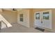 Covered porch featuring double entry doors and modern lighting fixtures at 12500 Green Oak Ln, Dade City, FL 33525