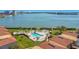 Scenic aerial view of a waterfront community with pool, landscaping, and beautiful bay views at 6158 Palma Del Mar S Blvd # 604, St Petersburg, FL 33715