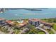 A scenic aerial view of condos, a community pool, and lush green lawns by the water at 6158 Palma Del Mar S Blvd # 604, St Petersburg, FL 33715