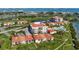 Expansive aerial view of community buildings, golf course, ponds, and lush landscaping at 6158 Palma Del Mar S Blvd # 604, St Petersburg, FL 33715