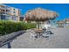 Outdoor dining area featuring shade under a thatched umbrella at 6158 Palma Del Mar S Blvd # 604, St Petersburg, FL 33715
