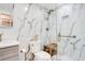 Updated bathroom featuring marble-style tile, glass shower with bench, and white vanity at 6158 Palma Del Mar S Blvd # 604, St Petersburg, FL 33715