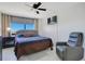 Calm bedroom with a plush bed, soft lighting, and a comfortable gray recliner at 6158 Palma Del Mar S Blvd # 604, St Petersburg, FL 33715
