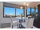 Cozy dining area with a round marble table, stylish white chairs, and a scenic window view at 6158 Palma Del Mar S Blvd # 604, St Petersburg, FL 33715