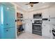 Stylish kitchen featuring white cabinetry, stainless steel appliances, and a unique vintage blue refrigerator at 6158 Palma Del Mar S Blvd # 604, St Petersburg, FL 33715