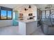 Charming kitchen featuring white cabinetry, a modern island, stainless steel appliances, and a vintage blue refrigerator at 6158 Palma Del Mar S Blvd # 604, St Petersburg, FL 33715