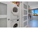 Laundry closet featuring a stacked washer and dryer and access to the hallway and window at 6158 Palma Del Mar S Blvd # 604, St Petersburg, FL 33715
