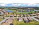 Aerial view of a residential community with houses, golf course, and scenic ponds at 6914 Quiet Creek Dr, Bradenton, FL 34212