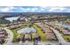 Aerial view of a residential area featuring homes with tile roofs and scenic ponds at 6914 Quiet Creek Dr, Bradenton, FL 34212
