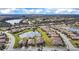Aerial view of a home in a gated community with lake views and lush landscaping at 6914 Quiet Creek Dr, Bradenton, FL 34212
