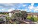 An aerial view showcases this two-story home with a tile roof, lush landscaping and a brick driveway at 6914 Quiet Creek Dr, Bradenton, FL 34212