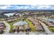 Beautiful aerial view of a home in a quiet community with picturesque lake views and lush landscaping at 6914 Quiet Creek Dr, Bradenton, FL 34212