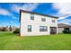 A well-maintained backyard with a lush lawn, a screen door, and a view of the white two-story house at 6914 Quiet Creek Dr, Bradenton, FL 34212